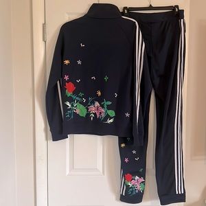 Adidas Originals track suit. Floral designs on back of suit.